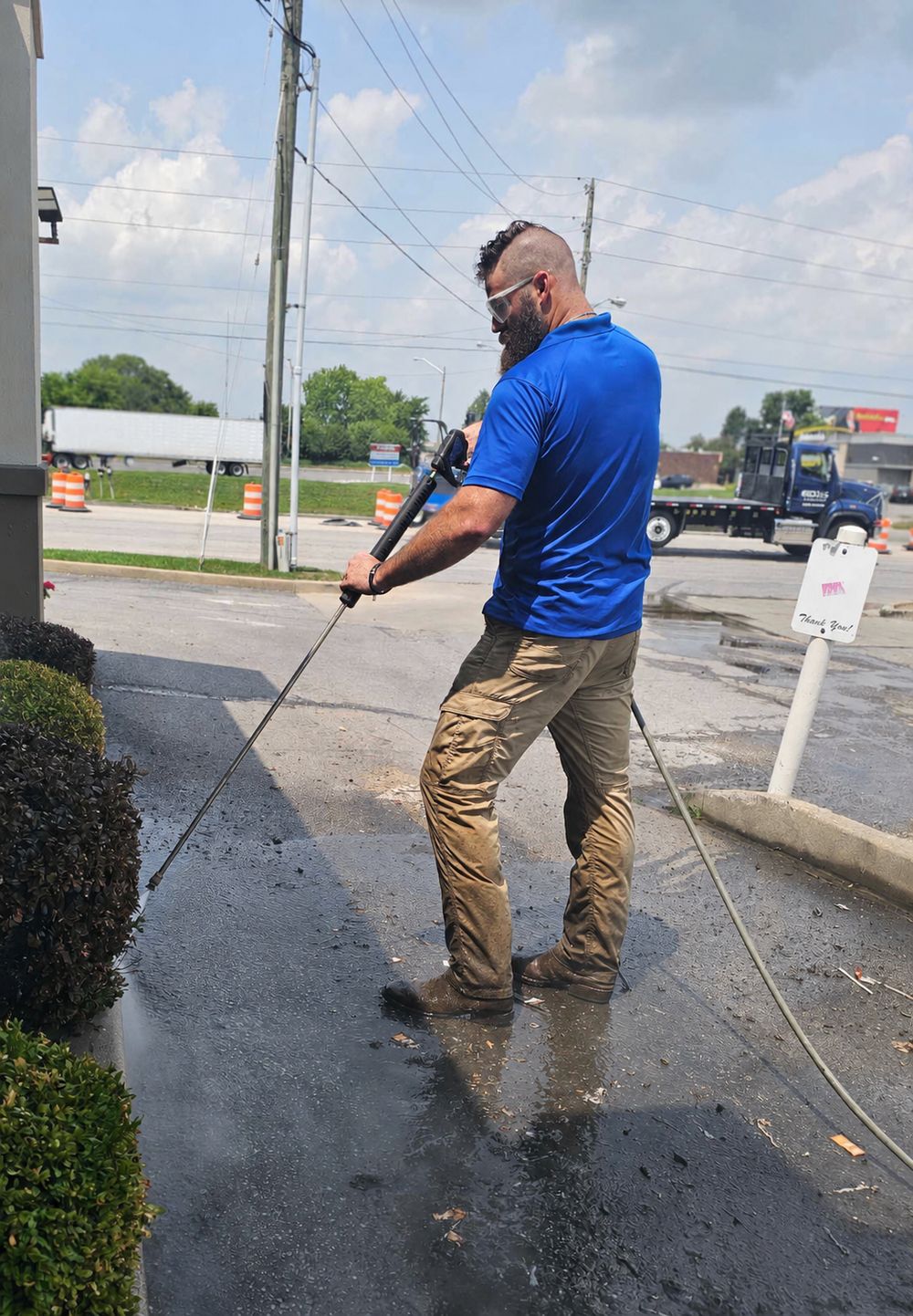Pressure washing a sidewalk, spray in action