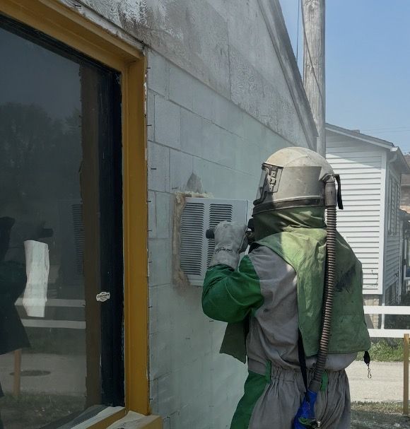 Sandblasting paint off a block wall